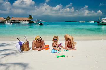 Family on beach, young couple with three year old boy. Summer vacation at Maldives.