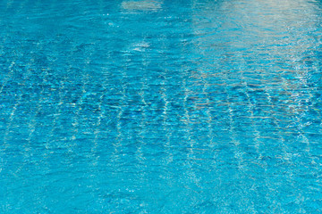 blue abstract ripple water textured in swimming pool with summer sunlight background
