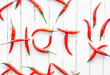 Wall Mural - Hot red pepper on a white wooden vintage background.