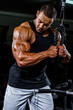 © mrbigphoto - Body Builder Exercise Triceps at the Gym. Performing Triceps Rope Pushdowns