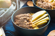 © tenkende - Turmeric amaranth porridge served with apples, flax seeds and almonds. Healthy plant based vegan breakfast.