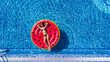 © F8  \ Suport Ukraine - Beautiful young woman in bikini with inflatable watermelon tanning in pool. Above view of Woman in swimming pool.
