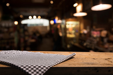 Table background with napkin and blurred bar background space