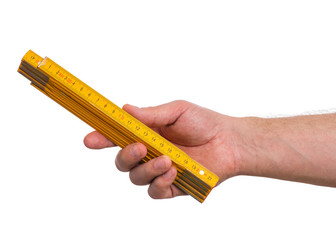 Male Hand with yellow wooden meter. Human Hand holding tool, Isolated on White Background.