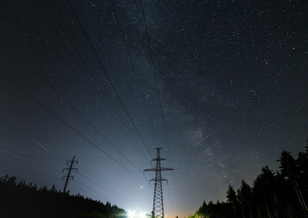 Canvas Print - Power lines against the starry sky.