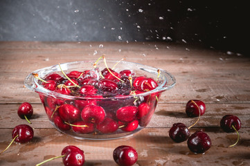 Fresh cherry in bowl on rustic background