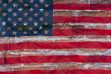 Brown Brick Wall On American Flag Background. The Concept Of Crisis