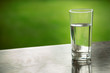 Glass of water purified fresh drink water on table outdoors