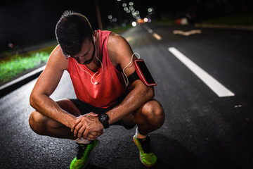 Wall Mural - Man resting after night workout in the city.