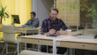 © vadosloginov - A bearded man talking on a tablet in the eco office workers work