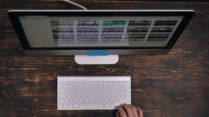 Leinwandbilder - Working place with wooden desk display and keyboard. top view invisible man working on computer. Designer search information for project