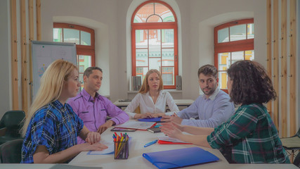 Poster - Portrait successful young business team in contemporary office. Diverse group of people at the meeting or brainstorming looking at the camera. Casual professional women and men sitting in boardroom.