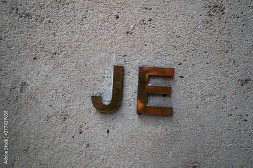 The Initials Je Are Pictured On The Wall By The Front Door Of The
