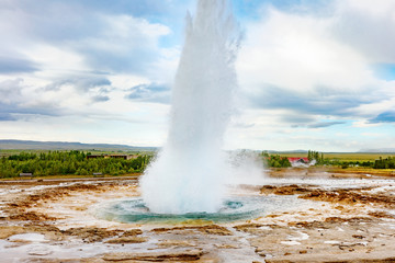 Iceland, Golden Circle touristic itinerary - iconic landmark Strokkur Geysir. Eruption of Strokkur geyser in Iceland.  Natural wonder - hot sprint that erupting every 5 minutes. Geothermal fields. 