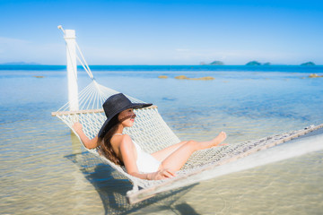 Portrait beautiful young asian woman sitting on hammock around sea beach ocean for relax