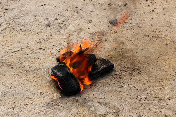 burnt mobile phones on textural concrete background. Concept: Danger of using low-quality cell phones.