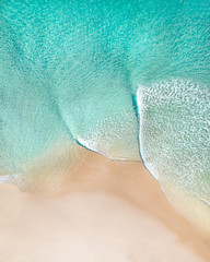 Wall Mural - Aerial of a beach with beautiful waves, white sand and ocean textures