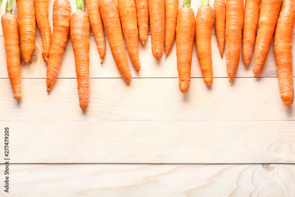Tasty fresh carrot on wooden background