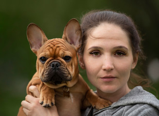 Wall Mural - girl portrait with french bulldog puppy