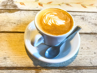 Canvas Print - Cup of cappuccino with pattern on old wooden table. 