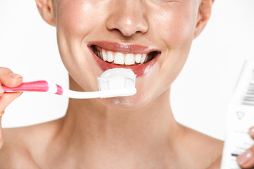 Canvas Print - Image of beautiful half-naked woman cleaning her teeth with toothpaste and toothbrush