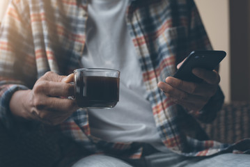 man using smartphone at coffee shop