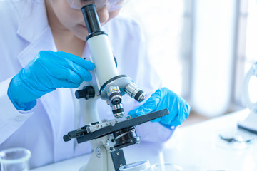 Wall Mural - scientists analyzing study data and evaluating microscope. health care researchers doing some resear