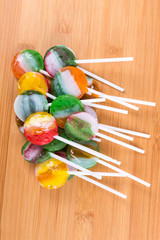 Wall Mural - Colorful arrangement of candy suckers on sticks