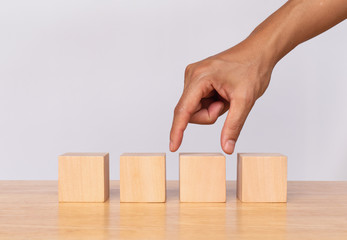 Wall Mural - Hand choose empty wooden blocks on white background. Concept of decision making and choices success in the future goal