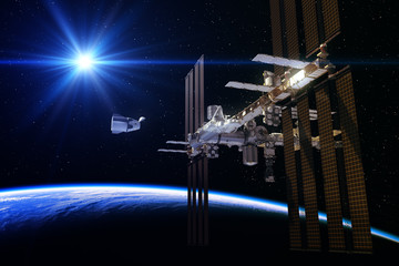 Wall Mural - commercial spacecraft and international space station in the rays of sun