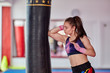 © Xalanx - Muay thai girl practicing with heavy bag