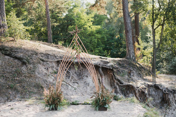 Coziness and style. Modern event design. Lounge zone and european traditional wedding ceremony decoration outdoors in the restaurant before the reception.