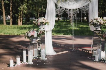 Coziness and style. Modern event design. Lounge zone and european traditional wedding ceremony decoration outdoors in the restaurant before the reception.