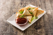 Samsa or samosas with meat and vegetables on wooden table . Traditional Indian food. 