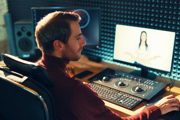 Male Videographer Edits and Cuts Footage and Sound on His Personal Computer