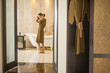 © triocean - Young woman in the bathroom wearing a robe getting ready to take a bath in the tub, wellbeing body care and beauty concept, spa weekend