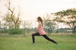 © reewungjunerr - Asian woman sit for stretching body on the lawn in the evening,Thailand people exercise at the park