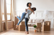 © fizkes - Happy african couple first time home buyers celebrate moving day