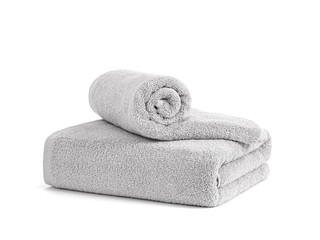 Gray terry towels rolled, folded and stacked isolated. Two terry towels against white backdrop. Folded and rolled soft bath towels. Stack of grey cotton towels on a white background