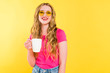 © LIGHTFIELD STUDIOS - beautiful smiling girl in sunglasses with coffee cup Isolated On yellow