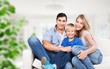 © BillionPhotos.com - Beautiful smiling family sitting at sofa at home
