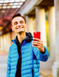 © Masson - handsome tall man in blue jacket with mobile phone