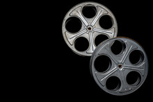 Two Vintage Film Reels On A Black Background With Copy Space