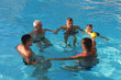 © aaalll3110 - 5 people swim in the pool forming a circle. People in the water holding hands