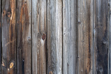 Old Peeling Wooden Boards. Background Natural Wooden Boards. Texture Of Old Unpainted Wooden Planks. Vertical Arrangement Of Shabby Wooden Boards.