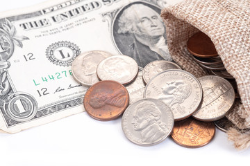 Money, US Dollars bank notes, penny, nickel, dime, quarter on a white background.