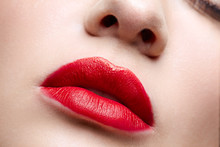 Closeup Macro Portrait Of Female Red Lips With Day Beauty Makeup. Girl With Perfect Lips Shape