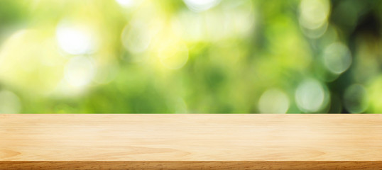 Aufkleber - wooden plank table top with blur tree in park with bokeh light at background,Mock up template for display of your design,Banner for advertise of product
