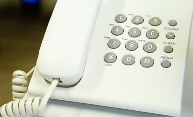 close up soft focus on telephone devices at office desk with light effect,communication technology concept