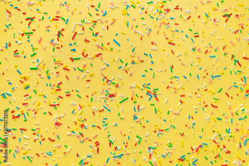 colorful sprinkles over yellow background, decoration for festive Valentines ...